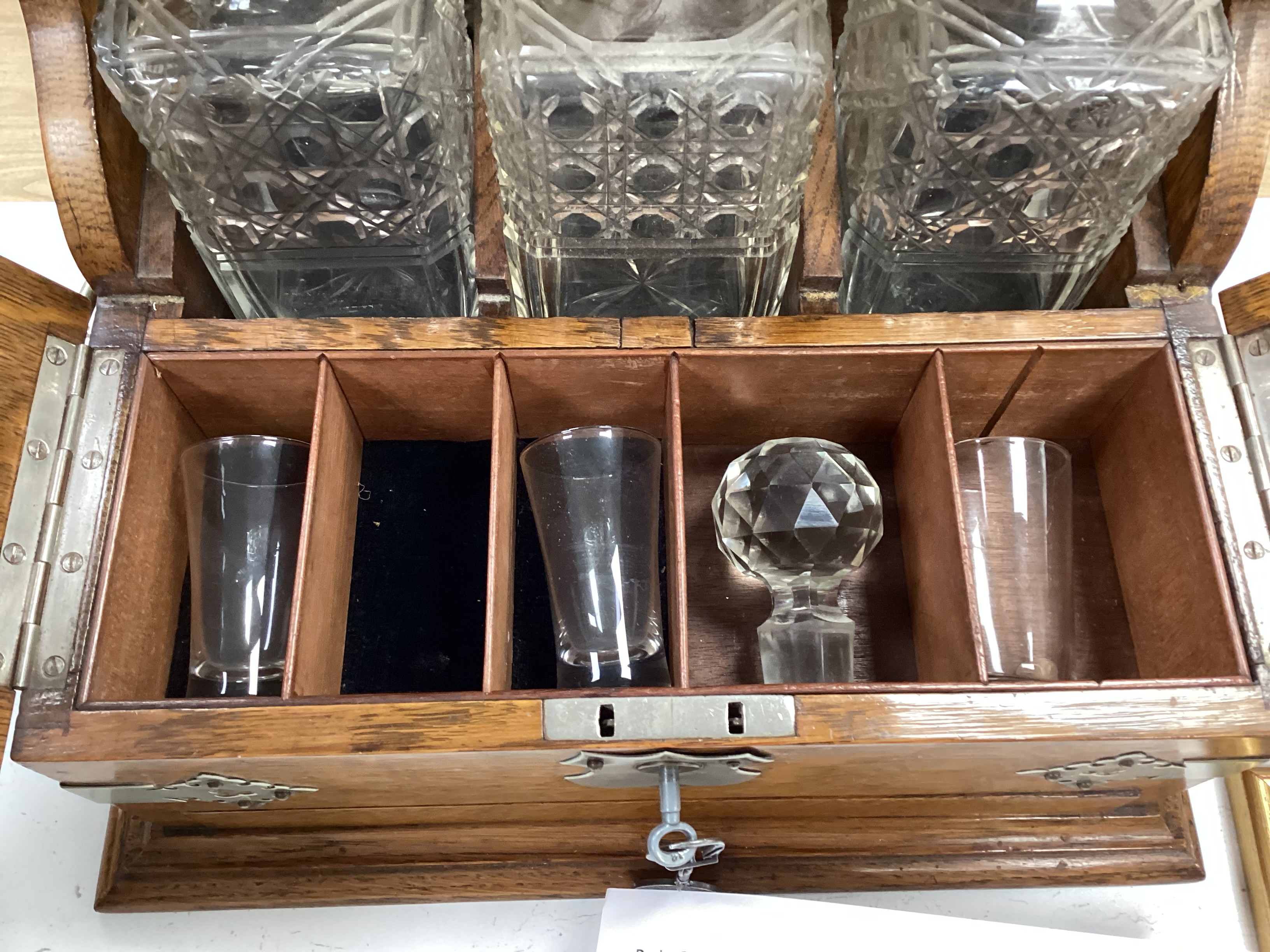 A Victorian three bottled oak nickel mounted tantalus,43cm high